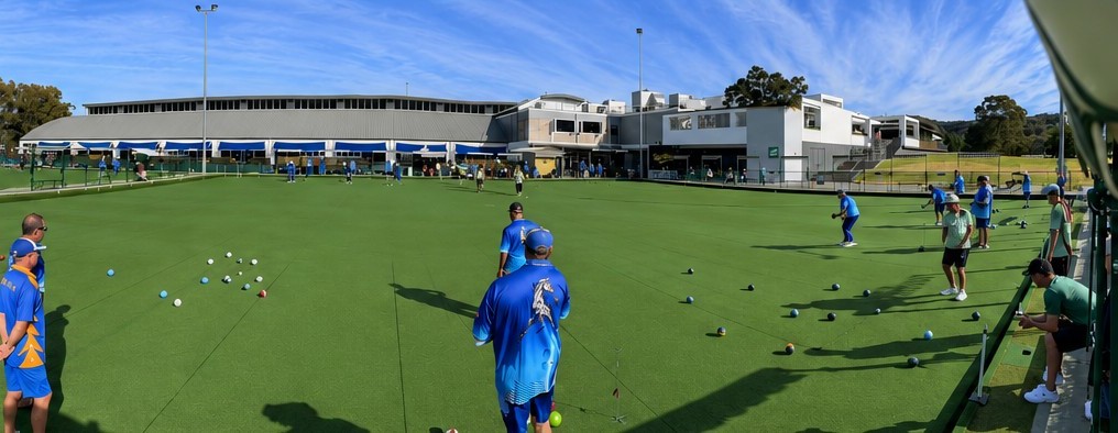 Bowlers in club colours playing on the Mingara greens